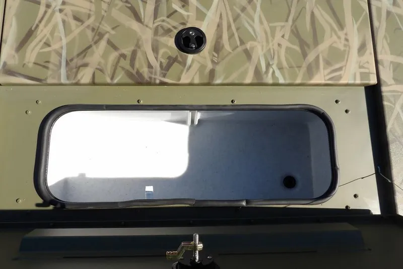Slide: The Image of 2026 Crestliner XFC 189 boat storage compartment with camouflage design. - 23
