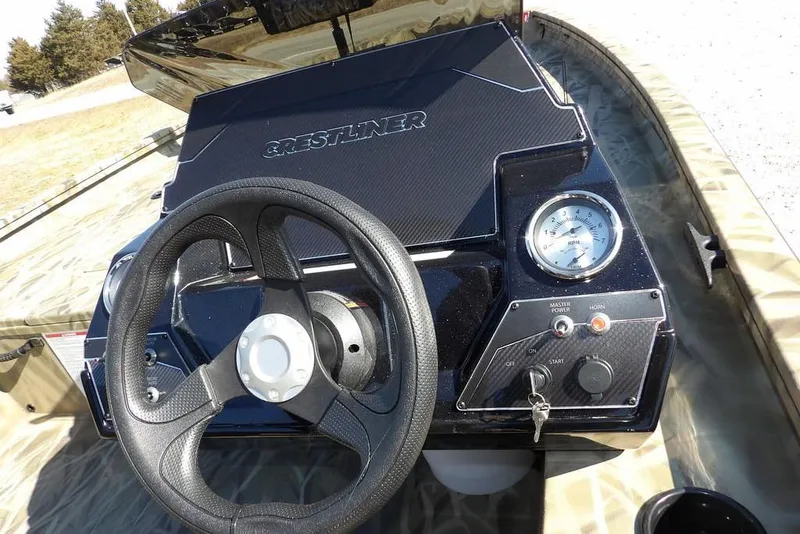 Slide: The Image of 2026 Crestliner XFC 189 boat dashboard with steering wheel and control panel. - 26