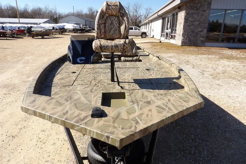 Slide: The Image of 2026 Crestliner XFC 189 fishing boat with camouflage design, parked outdoors. - 3