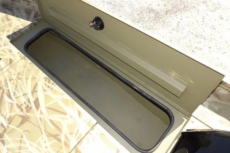 Slide: The Image of Storage compartment of 2026 Crestliner XFC 189 boat, featuring a secure lock mechanism. - 31