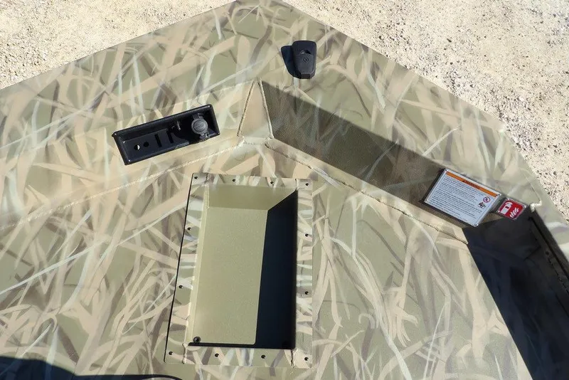 Slide: The Image of 2026 Crestliner XFC 189 boat interior with camo design and storage compartment. - 32