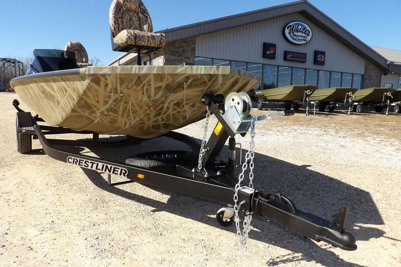 Slide: The Image of 2026 Crestliner XFC 189 boat on trailer outside marine center. - 35