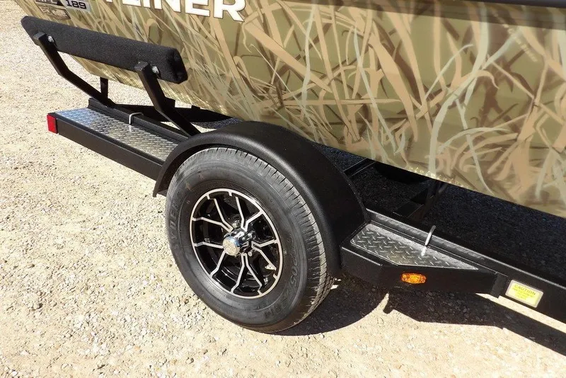 Slide: The Image of 2026 Crestliner XFC 189 boat trailer with camouflage design and black alloy wheel. - 36