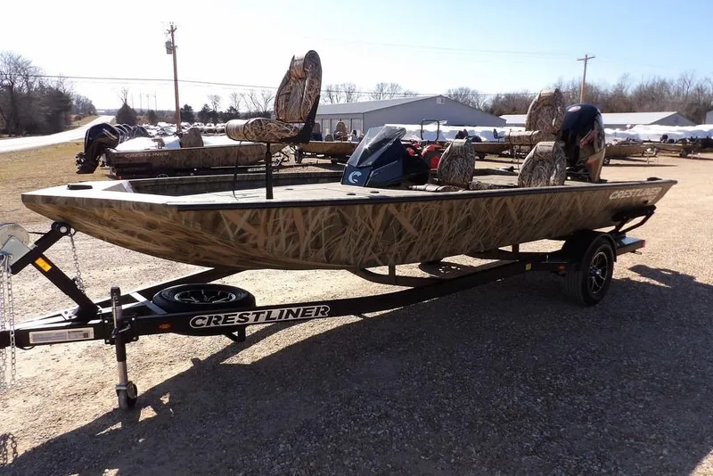 Slide: The Image of 2026 Crestliner XFC 189 fishing boat with camouflage design on a trailer. - 4