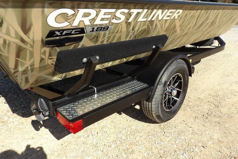 Slide: The Image of 2026 Crestliner XFC 189 boat on trailer with camouflage design and black wheel. - 40