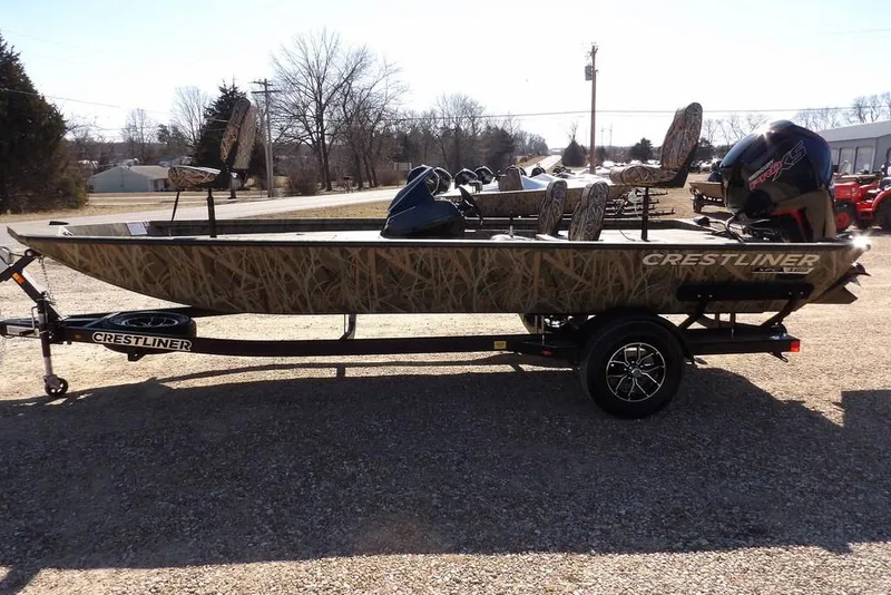 Slide: The Image of 2026 Crestliner XFC 189 fishing boat with camouflage design on a trailer. - 7