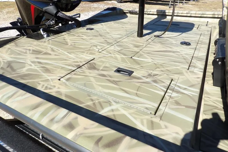 Slide: The Image of 2026 Crestliner XFC 189 boat deck with camo pattern and storage compartments. - 8