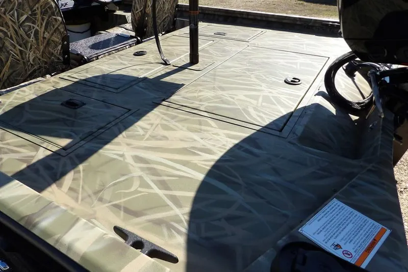 Slide: The Image of 2026 Crestliner XFC 189 boat deck with camouflage pattern and storage compartments. - 9