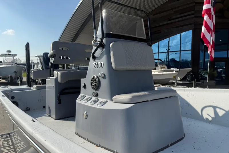 Slide: The Image of 2022 Blazer Bay 2400 boat with seating and control panel, displayed outdoors. - 9