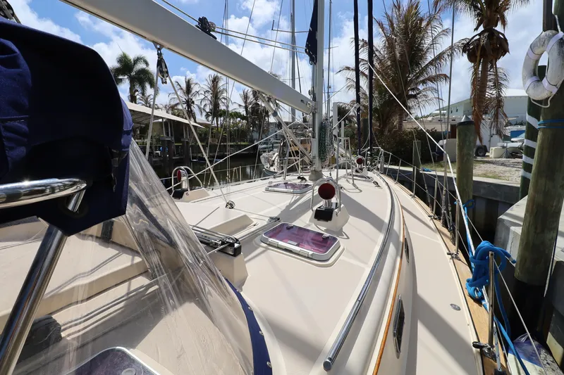 Slide: The Image of 2006 Island Packet 440 sailboat docked, showcasing deck and rigging under clear skies. - 29