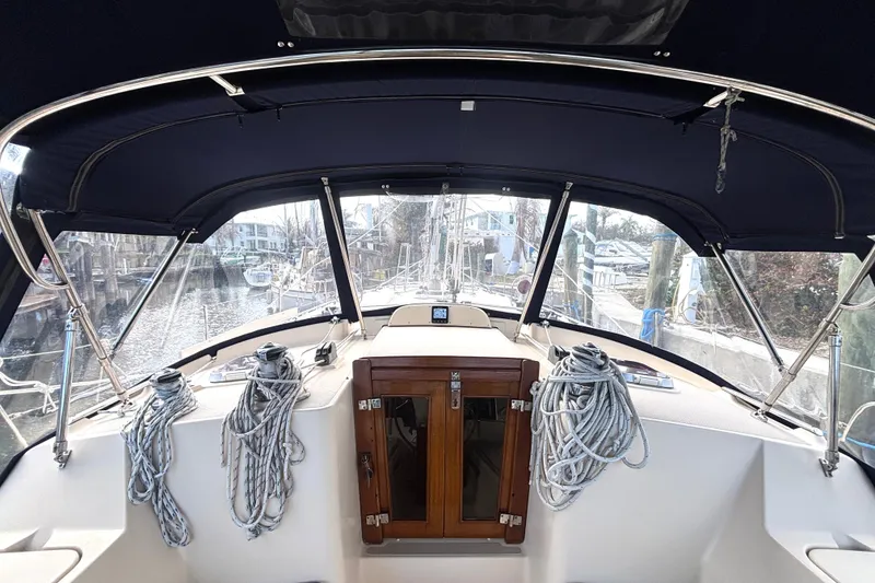 Slide: The Image of Cockpit view of 2006 Island Packet 440 sailboat with ropes and wooden hatch. - 6