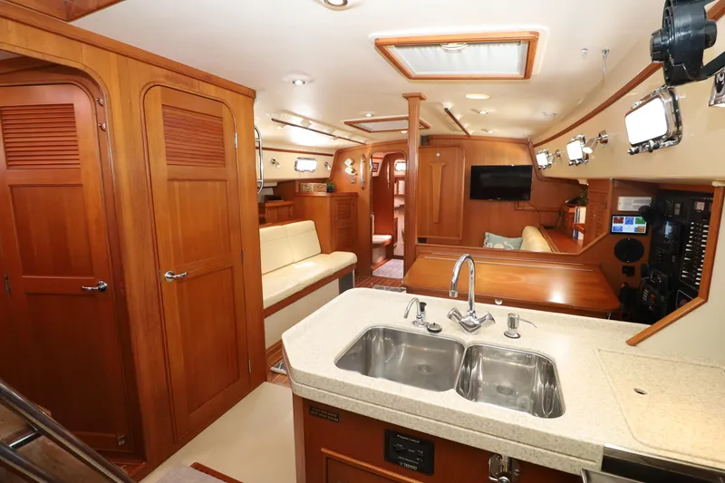 Slide: The Image of Interior of 2006 Island Packet 440 yacht, featuring wood cabinetry and modern amenities. - 8
