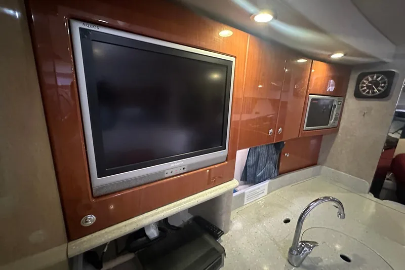 Slide: The Image of Interior of 2005 Formula 37 PC yacht with TV, microwave, and modern cabinetry. - 16