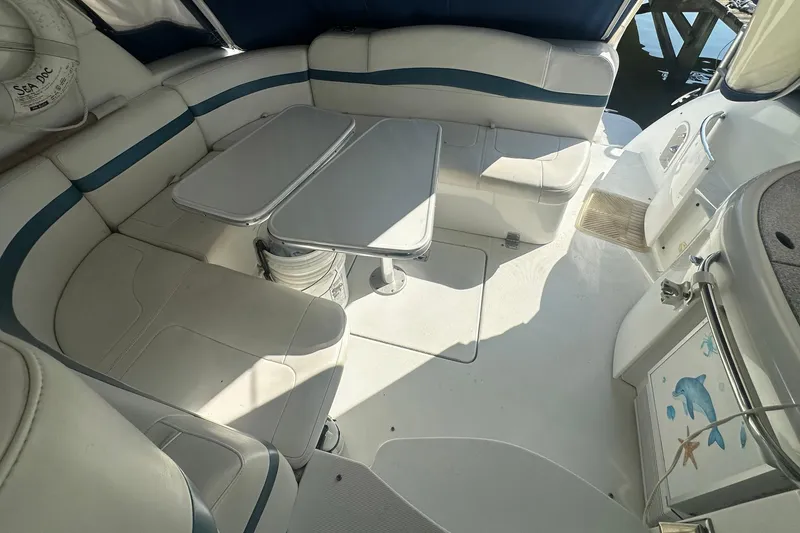 Slide: The Image of 2005 Formula 37 PC boat interior with white seating and foldable table. - 2