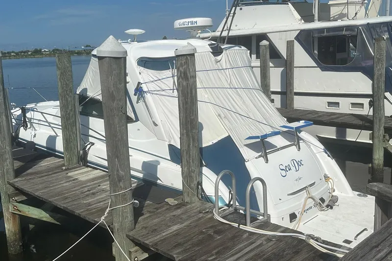 Slide: The Image of 2005 Formula 37 PC boat docked, covered, with "Sea Doc" on the stern. - 29