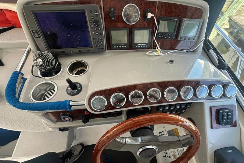 Slide: The Image of 2005 Formula 37 PC boat dashboard with gauges, controls, and navigation equipment. - 6