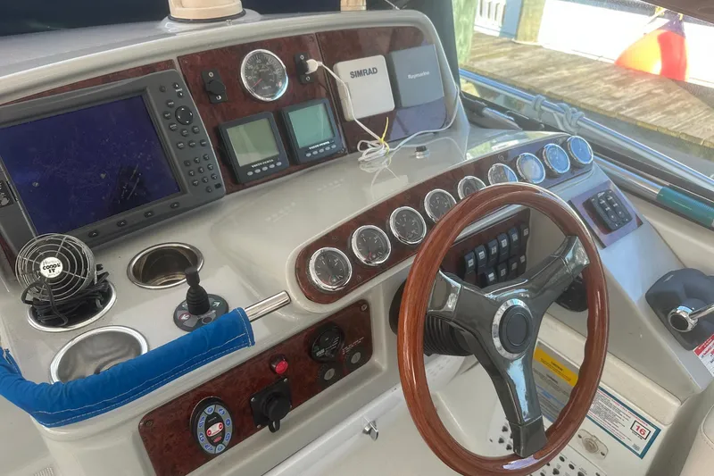 Slide: The Image of 2005 Formula 37 PC boat dashboard with steering wheel, gauges, and navigation equipment. - 7