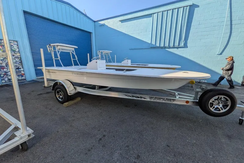 Slide: The Image of 2026 Mitzi Skiffs 17 Tournament boat with white seating and steering wheel at marina. - 8