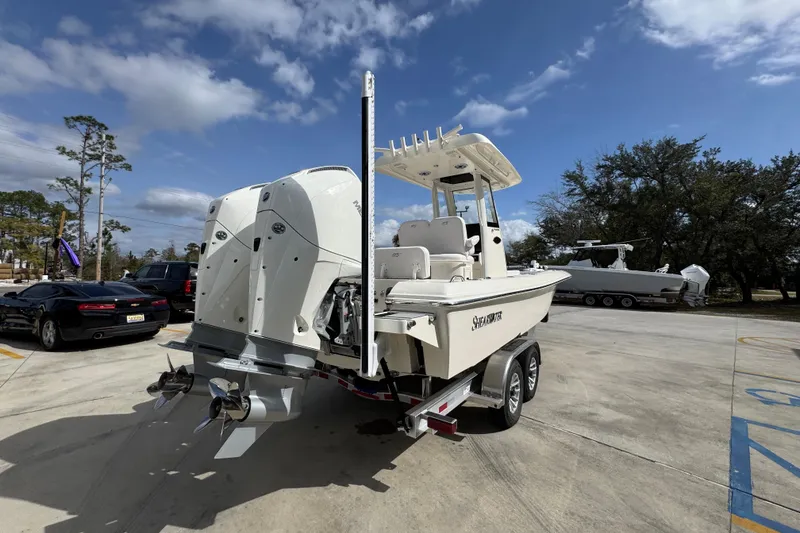 Slide: The Image of 2026 ShearWater 270 SS Open Carolina boat on trailer, parked outdoors under a cloudy sky. - 11