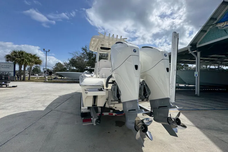 Slide: The Image of 2026 ShearWater 270 SS Open Carolina boat with dual outboard motors in a marina setting. - 13