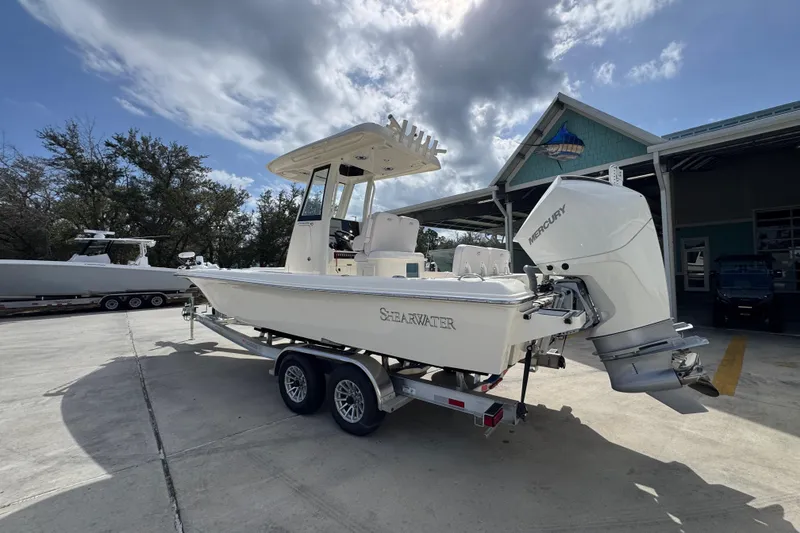 Slide: The Image of 2026 ShearWater 270 SS Open Carolina boat on trailer, parked outdoors under cloudy sky. - 14