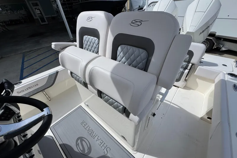 Slide: The Image of 2026 ShearWater 270 SS Open Carolina boat interior with luxury seating and steering wheel. - 28