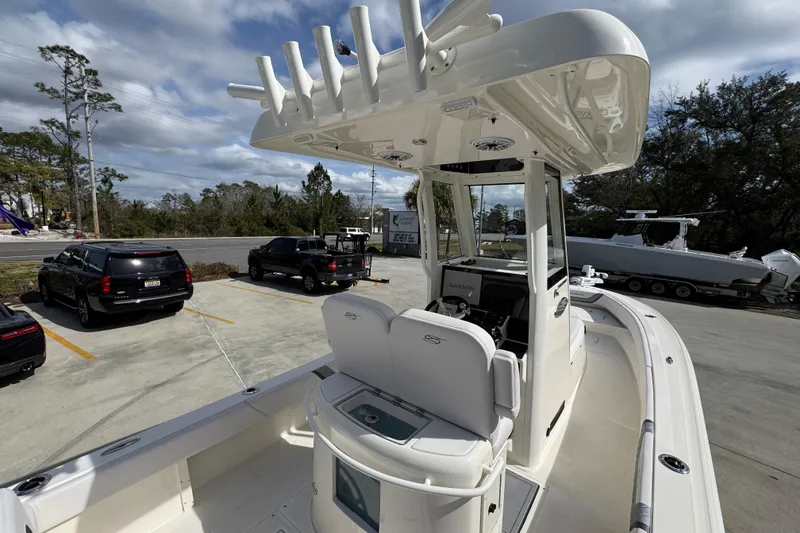 Slide: The Image of 2026 ShearWater 270 SS Open Carolina boat, parked outdoors, showcasing helm and seating area. - 39