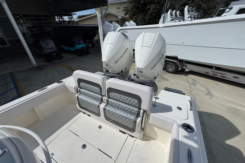 Slide: The Image of 2026 ShearWater 270 SS Open Carolina boat with dual Mercury engines at a marina. - 41