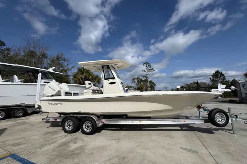 Slide: The Image of 2026 ShearWater 270 SS Open Carolina boat on trailer under blue sky. - 7