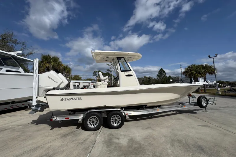 Slide: The Image of 2026 ShearWater 270 SS Open Carolina boat on trailer under blue sky. - 9