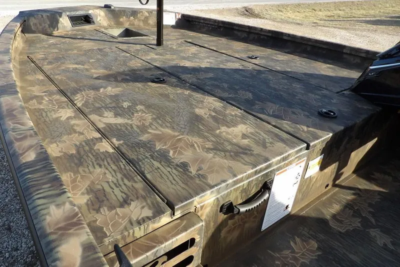 Slide: The Image of 2026 Crestliner XF 189 boat with camouflage deck design, featuring storage compartments. - 10