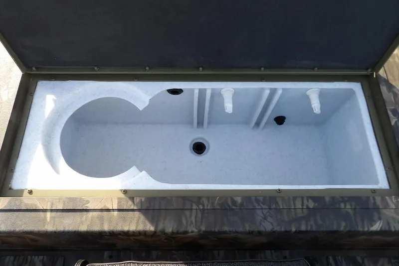 Slide: The Image of Livewell compartment in 2026 Crestliner XF 189 boat, featuring dual aerator nozzles. - 13