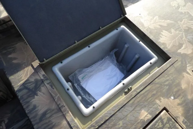 Slide: The Image of Storage compartment in 2026 Crestliner XF 189 boat, featuring camouflage design. - 14