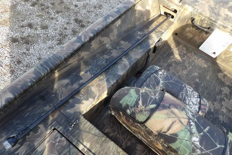 Slide: The Image of 2026 Crestliner XF 189 boat interior with camouflage seating and storage. - 15