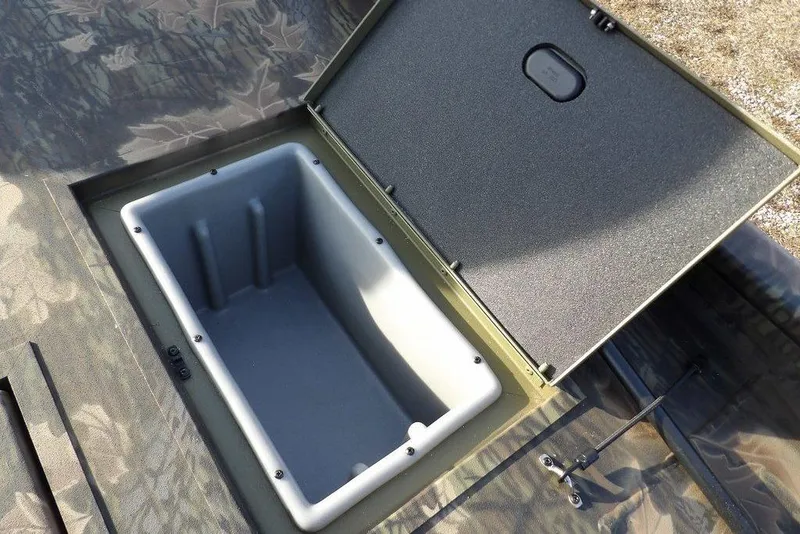 Slide: The Image of Open storage compartment in 2026 Crestliner XF 189 boat, featuring camouflage design. - 18