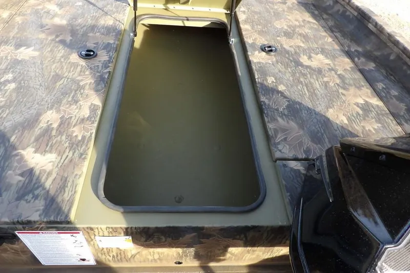 Slide: The Image of 2026 Crestliner XF 189 boat with open storage compartment, camo pattern deck. - 22