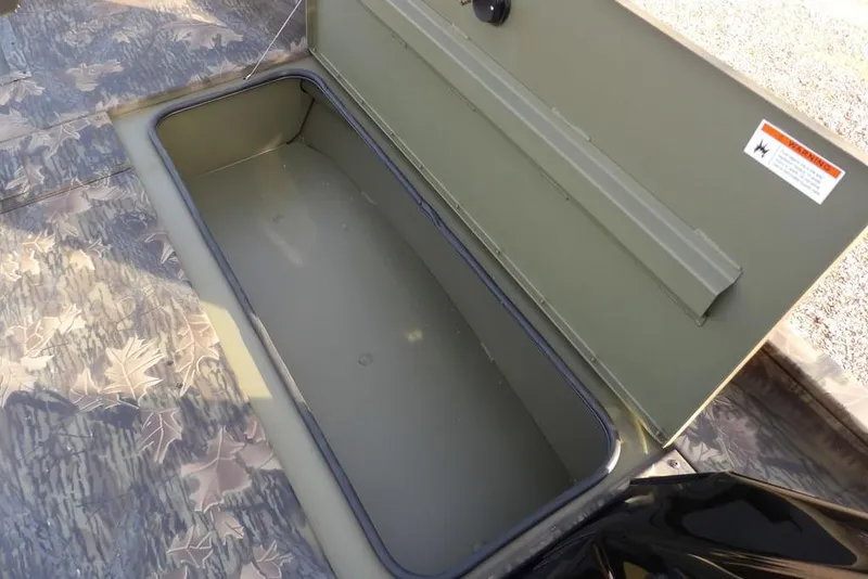 Slide: The Image of 2026 Crestliner XF 189 boat storage compartment with camouflage flooring. - 23