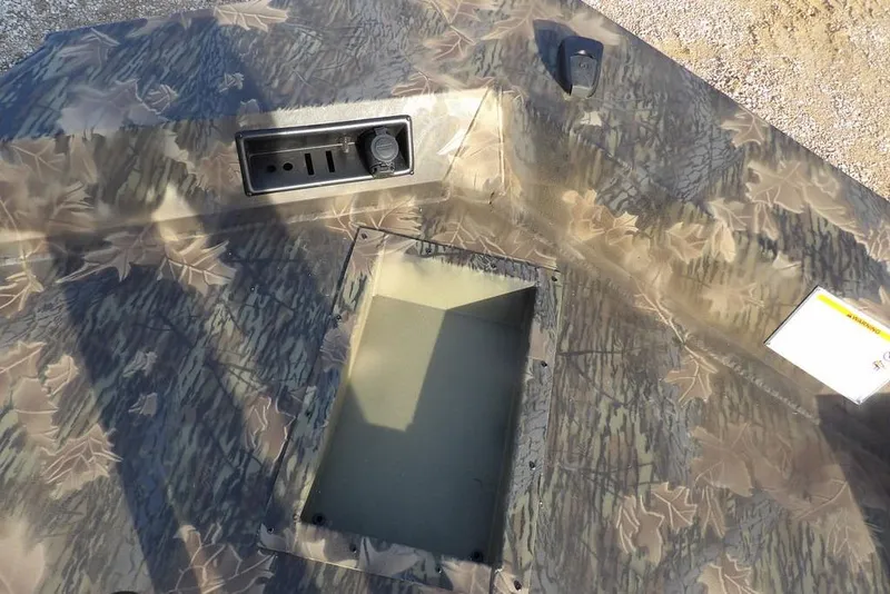 Slide: The Image of 2026 Crestliner XF 189 boat deck with camouflage pattern and storage compartment. - 27