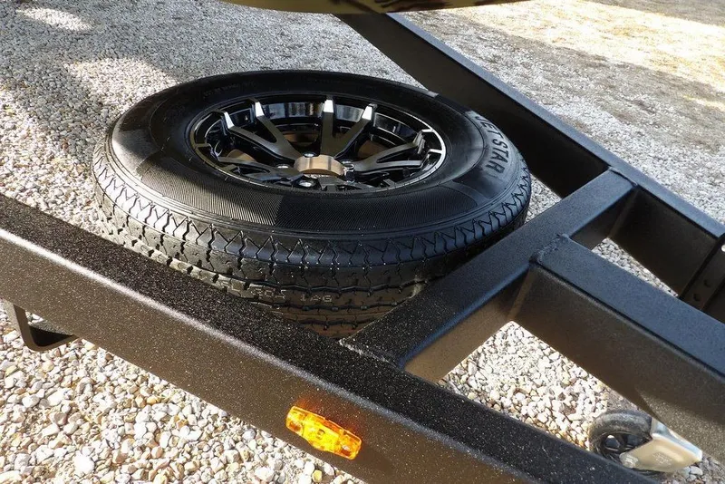 Slide: The Image of 2026 Crestliner XF 189 trailer with spare tire on gravel surface. - 28
