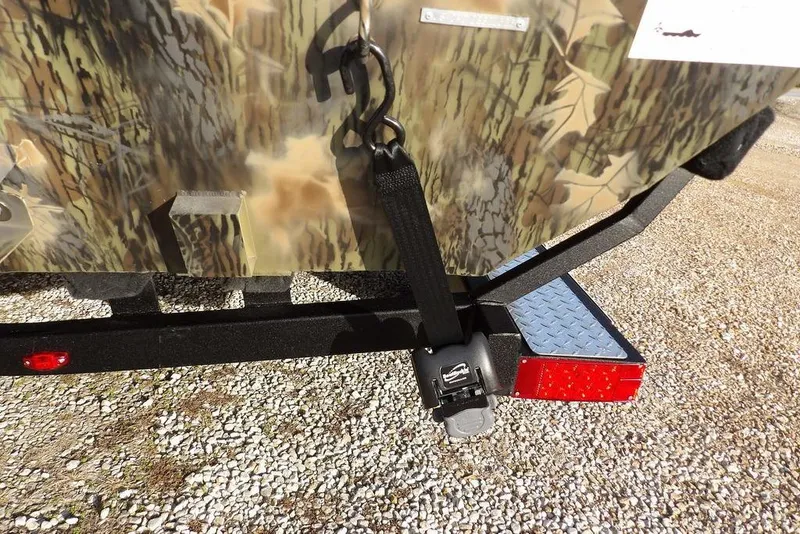 Slide: The Image of 2026 Crestliner XF 189 boat trailer with camouflage design and secure strap. - 36