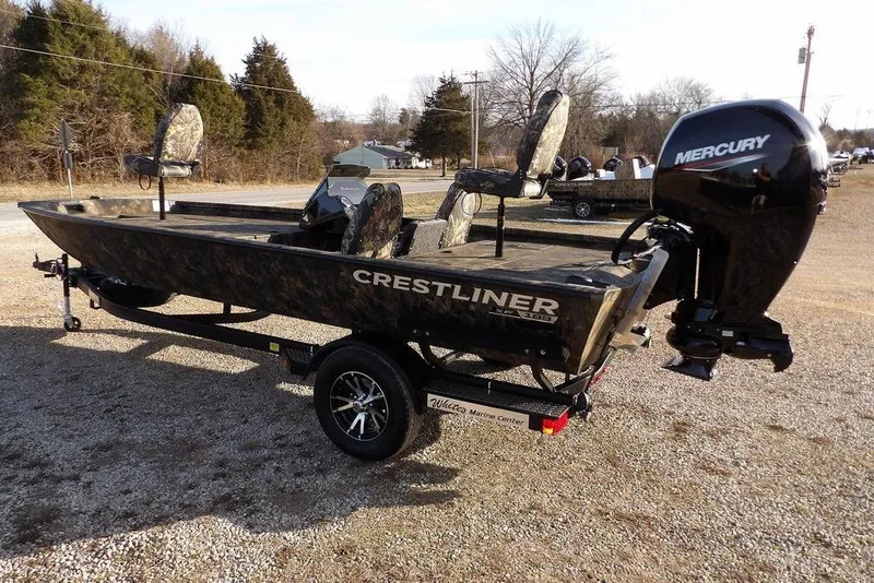 Slide: The Image of 2026 Crestliner XF 189 boat with Mercury engine on trailer, parked outdoors. - 6
