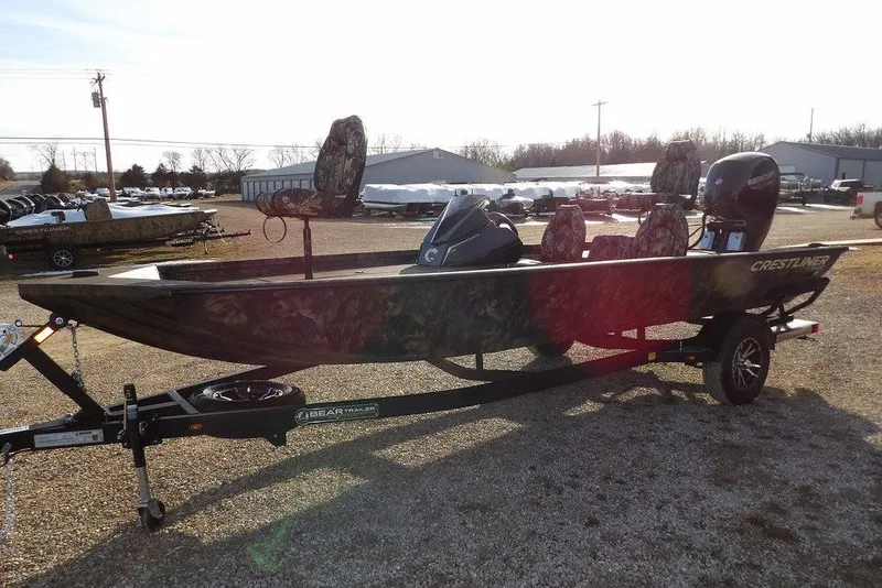 Slide: The Image of 2026 Crestliner XF 189 boat with camouflage seats on a trailer in a lot. - 8