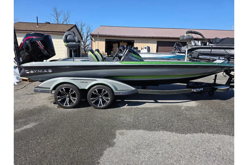 The Image of 2022 Caymas CX 21 boat with dual-axle trailer, parked outdoors. - 1