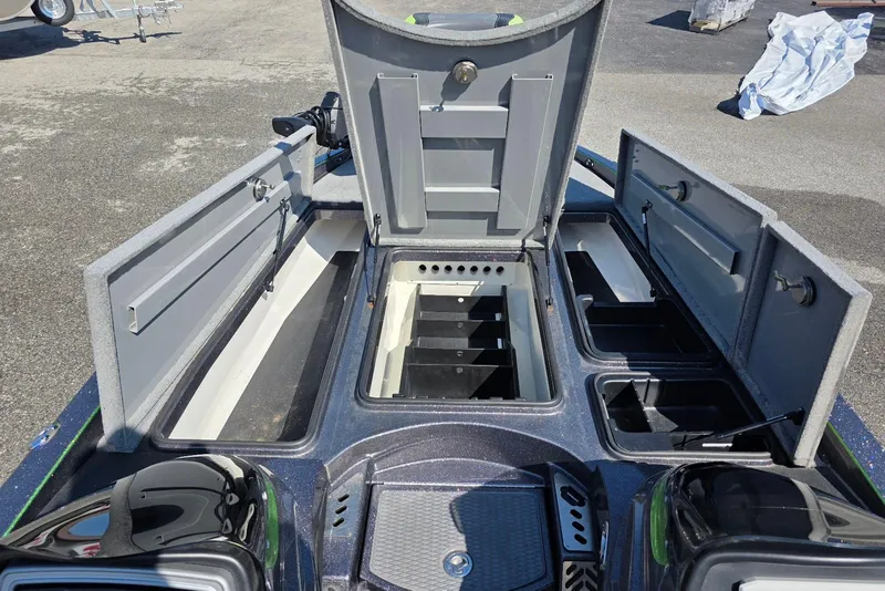 Slide: The Image of 2022 Caymas CX 21 boat storage compartments open, showcasing organized interior layout. - 11