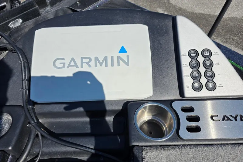 Slide: The Image of Garmin control panel on 2022 Caymas CX 21 boat dashboard with cup holder. - 13