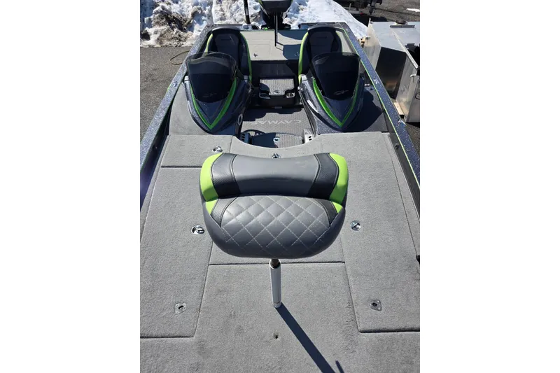 Slide: The Image of 2022 Caymas CX 21 boat interior with gray and green seating, snowy background. - 14