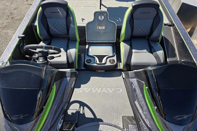 Slide: The Image of 2022 Caymas CX 21 boat interior with dual seats, steering wheel, and storage compartment. - 16