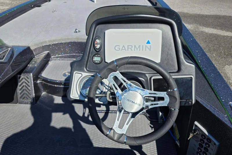 Slide: The Image of 2022 Caymas CX 21 boat dashboard with Garmin display and steering wheel. - 17