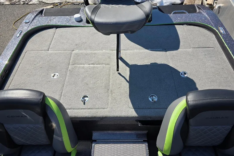 Slide: The Image of 2022 Caymas CX 21 boat interior with gray and green seating, spacious deck. - 19