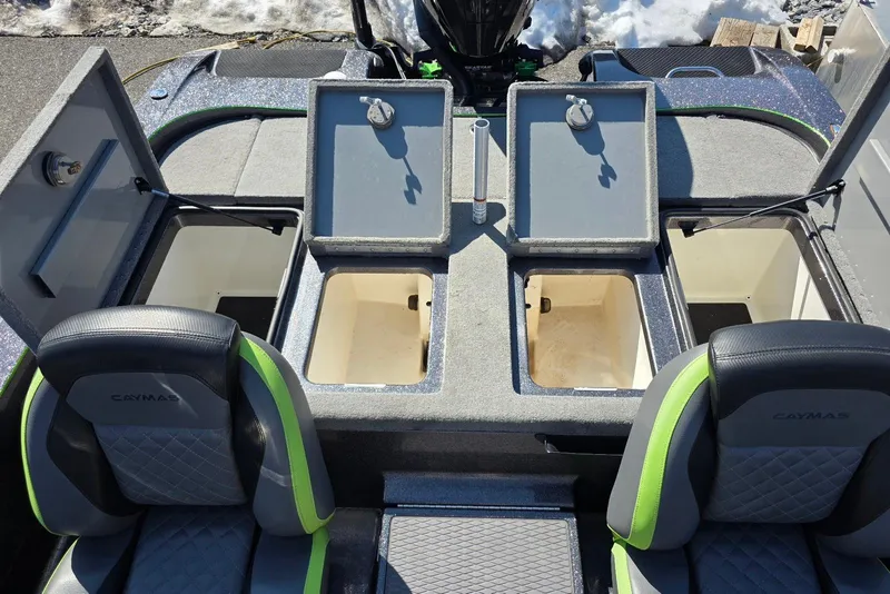 Slide: The Image of 2022 Caymas CX 21 boat interior with open storage compartments and cushioned seats. - 20